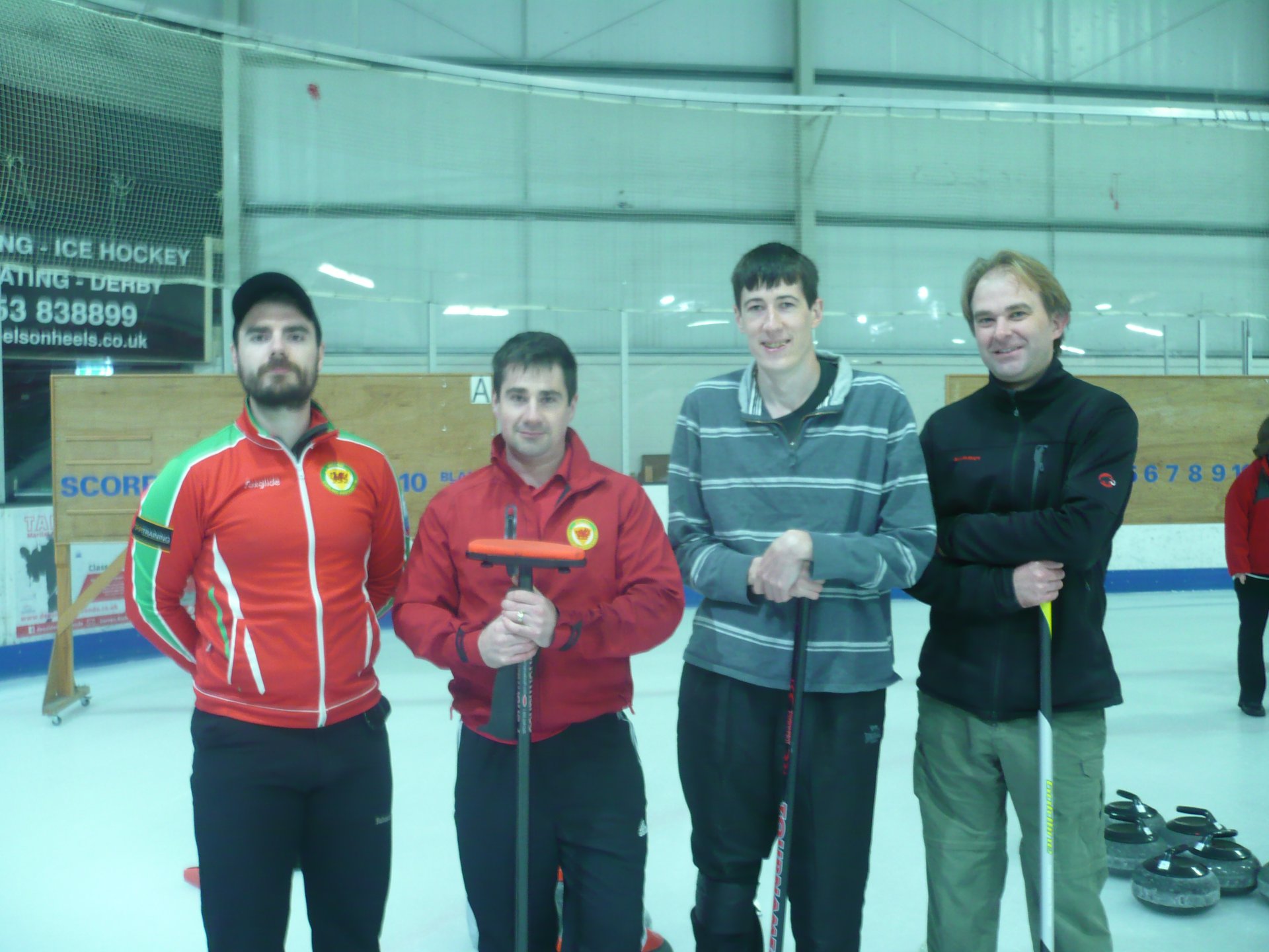 Photograph of Team Pougher, four white men in their thirties and forties stood in a row