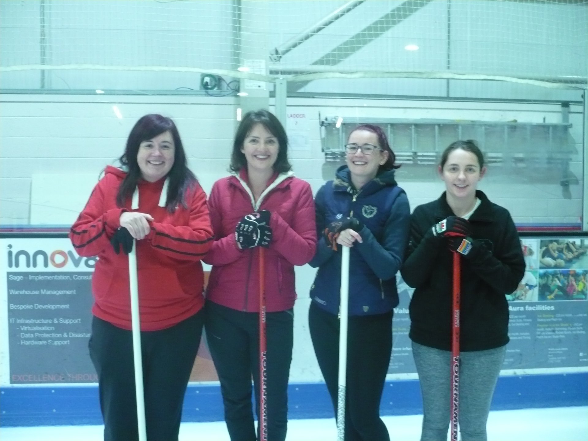Photogrpah of Team Beever, four white women with brunette hair, in their twenties and thirties, stood in a row